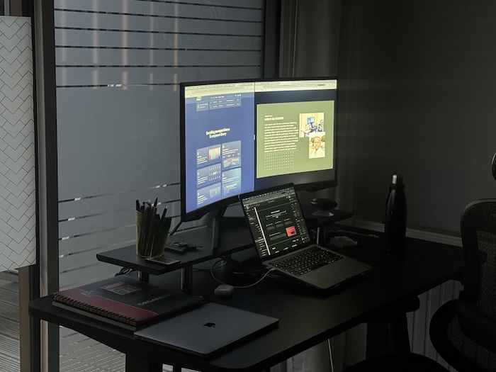 Developer setup with multiple screens and desk lighting